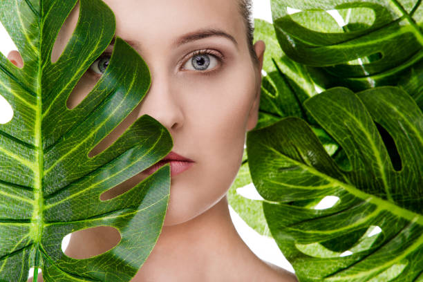 istock Woman portrait with tropical leaf 1072534328