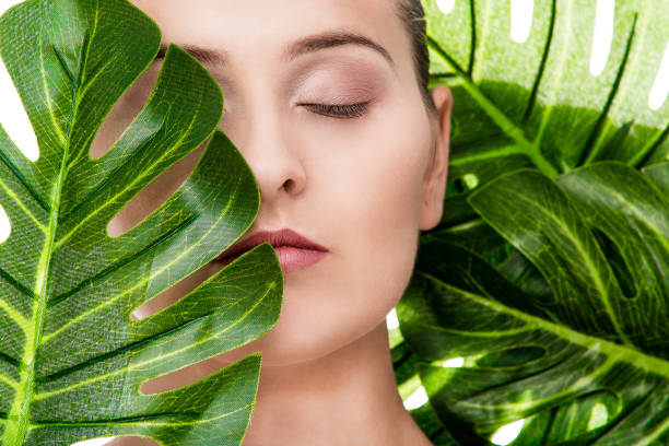 istock Woman portrait with tropical leaf 1072534462