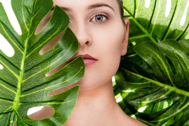 istock Woman portrait with tropical leaf 1072534518