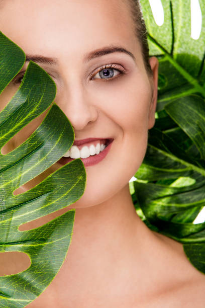 istock Woman portrait with tropical leaf 1072534746