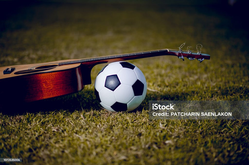 Guitar And Football Are Placed In Green Lawns Music And Sports Ideas And  There Is A Copy Space Stock Photo - Download Image Now - iStock