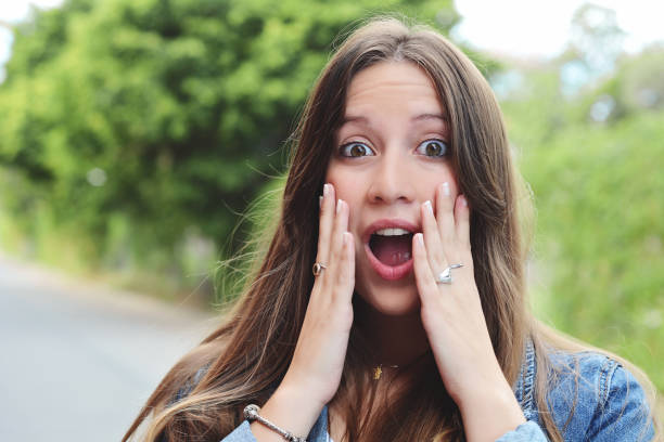 istock Young woman with surprised expression. Outdoor. 1072535250