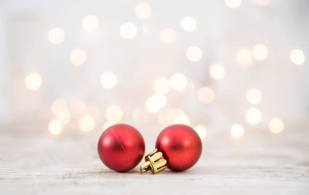 istock Two Red Christmas Balls On Wood Background 1072535420