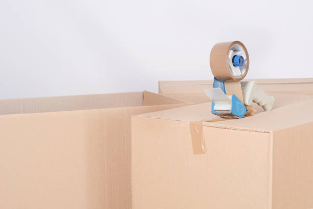 istock Tape dispenser sealing a shipping cardboard box 1072536598