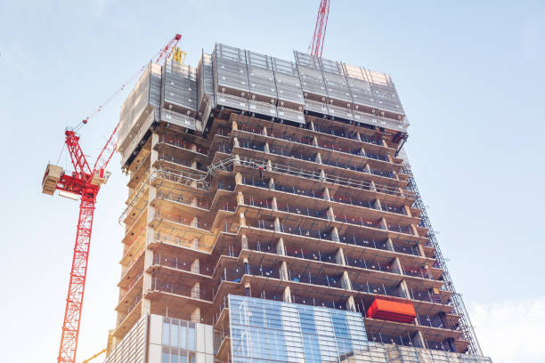 Building construction with crane Construction site of a new development in London, United Kingdom highrise condominiums stock pictures, royalty-free photos & images