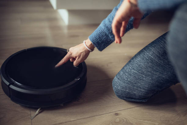 istock Turning on robot vacuum cleaner 1072539740