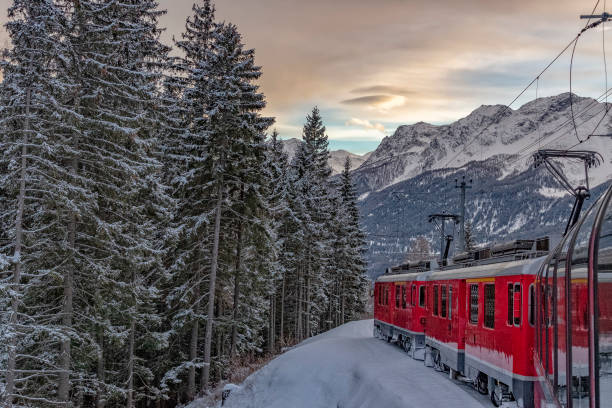 istock Red train in the snow in swiss alps 1072539894