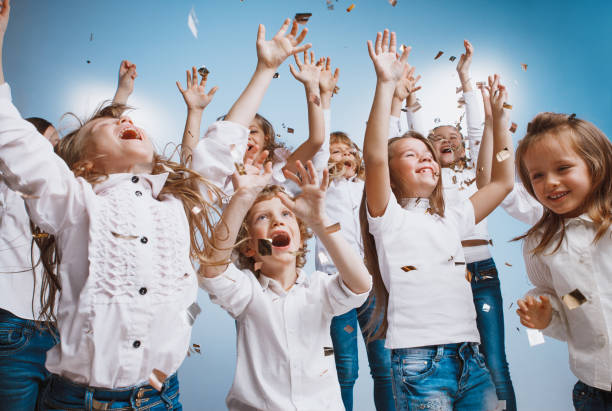 istock Adorable kids have fun together, throw colourful confetti, 1072543966