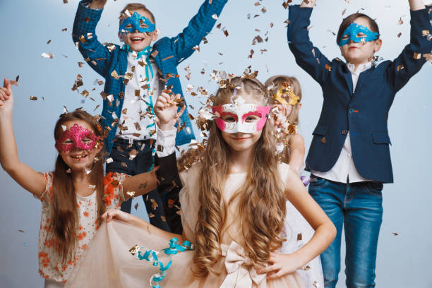 istock Adorable kids have fun together, throw colourful confetti, 1072543976