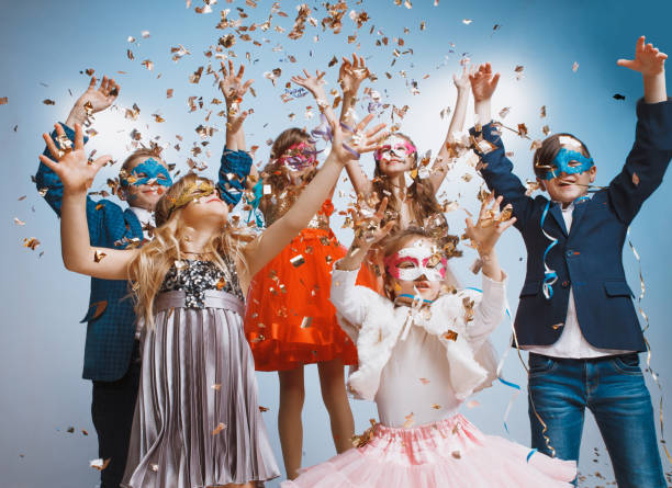 istock Adorable kids have fun together, throw colourful confetti, 1072543980