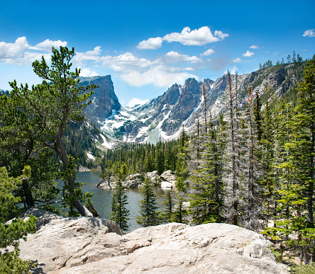 Beautiful mountain scenery. Early summer landscape with snow covered mountains.  Hallett Peak over the Dream Lake, Rocky Mountains National Park, Colorado, USA.