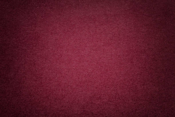Texture of old dark red paper background, closeup. Structure of dense cardboard. Texture of vintage dark red paper background with vignette. Structure of dense maroon kraft cardboard with frame. Felt wine gradient backdrop closeup. maroon photos stock pictures, royalty-free photos & images