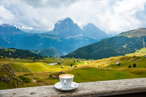 Coffee cup in coffee time on mountain view background, Dolotites, Italy