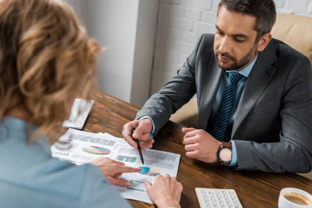 istock high angle view of business people working with documents together in office 1072553286