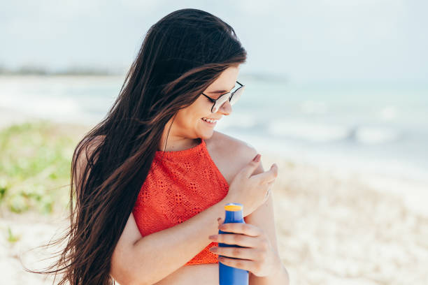 istock Woman applying sunscreen on her shoulder 1072555976