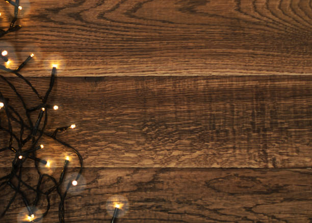 istock Christmas Light or Garland Lights on Wood Background 1072559300