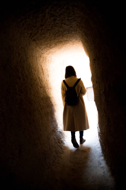 Woman Hiking Through a Cave in Cappadocia