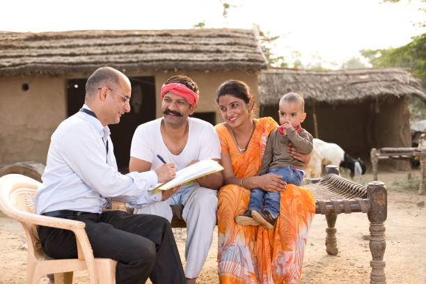 Indian family meeting with financial advisor Indian family meeting with financial advisor at village happy indian young family couple stock pictures, royalty-free photos & images