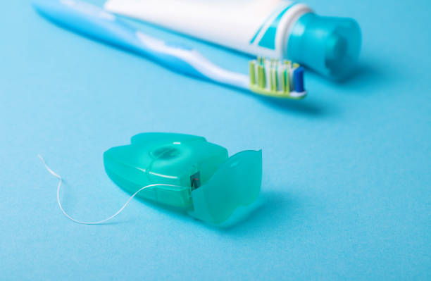 istock Dental floss and toothbrush on a blue background. 1072577470