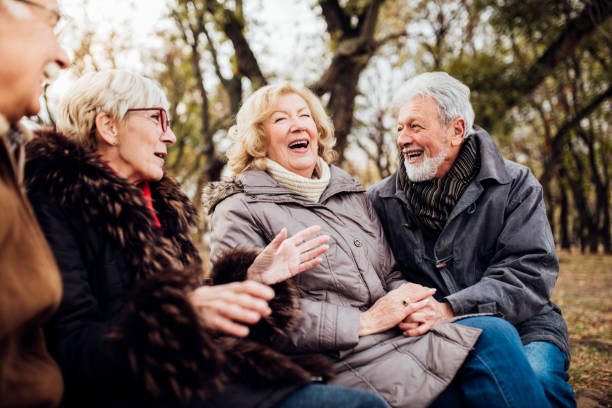 istock Cheerful senior couples sitting in the park 1072580268