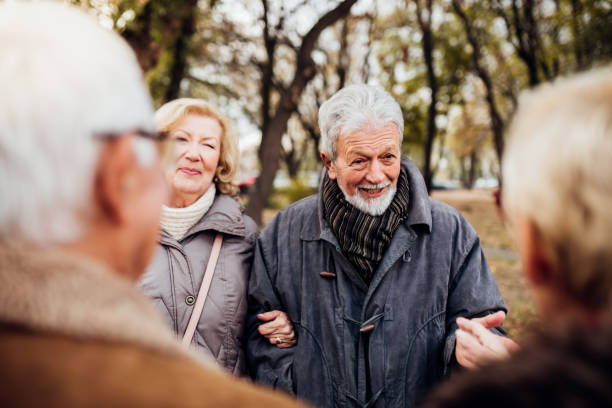 istock Two senior couples having a conversation in the park 1072580338