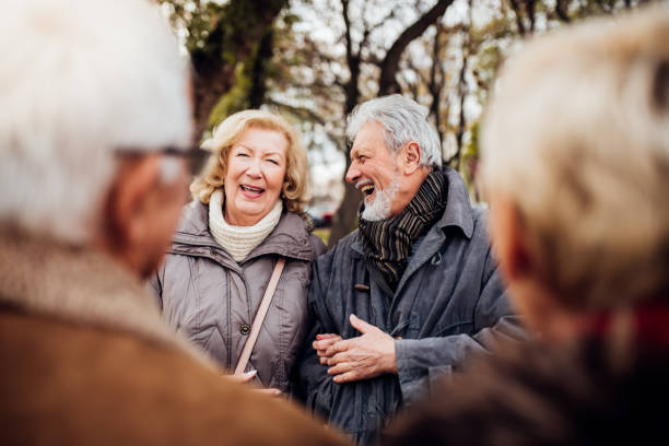 istock Senior couples laughing in the park 1072580428