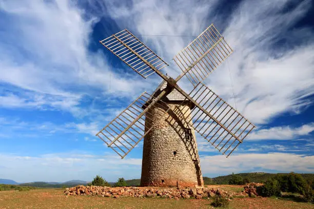 Photo of Stone windmill on a blue sky