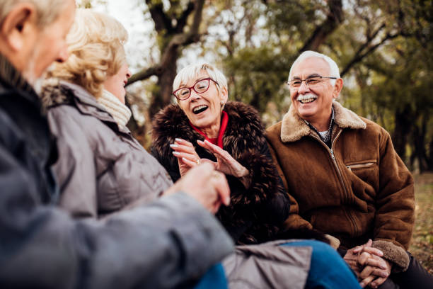 istock Two senior couples sitting in the park 1072580482