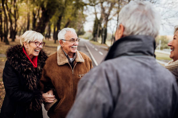 istock Happy senior couples talking in the park 1072580640