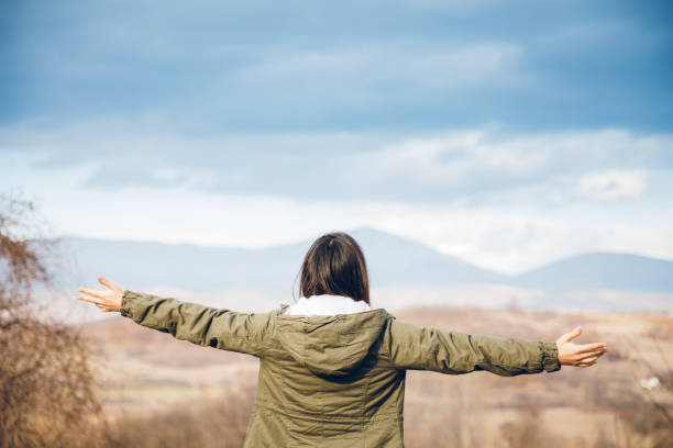 istock Woman spreading hands with joy in nature 1072580780