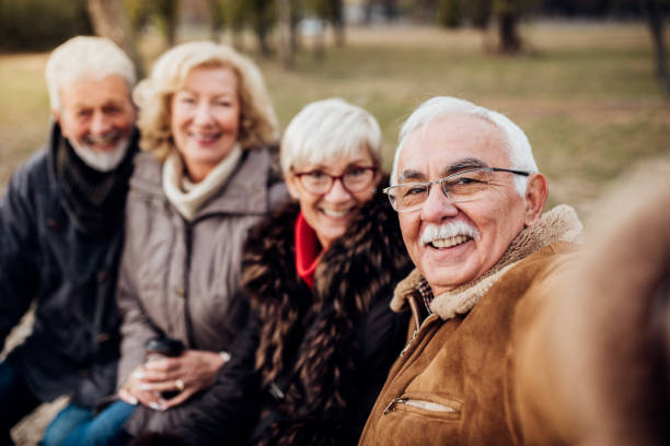istock Senior couples on a bench in a park 1072586872