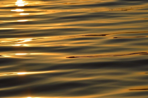Beautiful waves at sunset close up with bokeh effect
