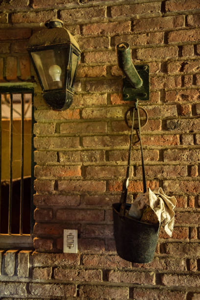 istock Brick wall with a lamp and a bucket with some fabrics on it and a light switch 1072590946