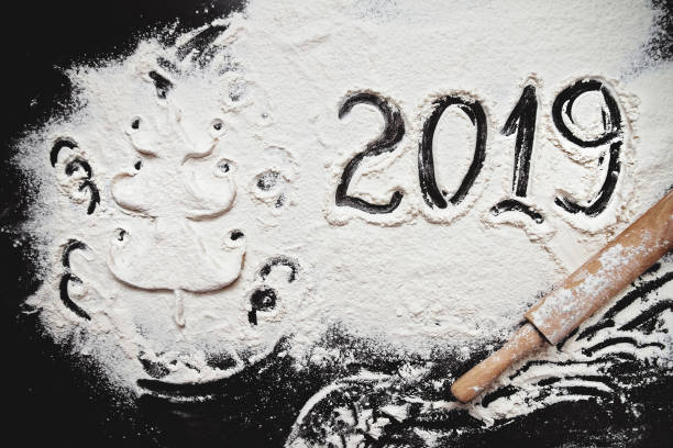 istock numbers 2019 paint on flour table and Christmas tree with confetti from white dough 1072593404