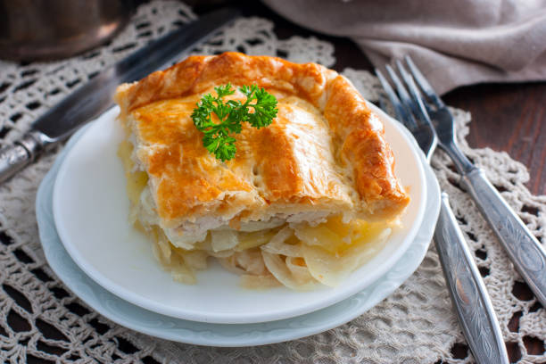 istock Sliced puff pastry cake with chicken, potatoes and onions, selective focus 1072595740