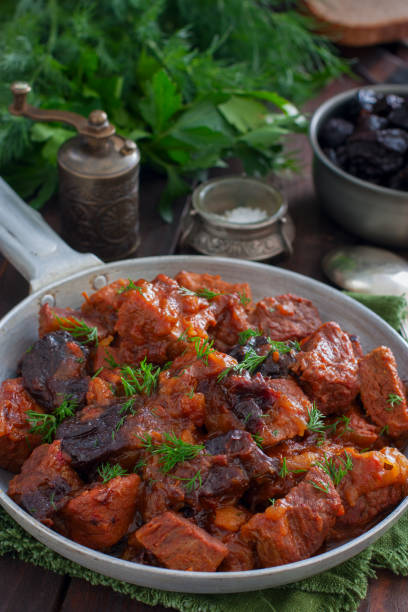 istock Stewed beef in tomato sauce with prunes, selective focus 1072598456