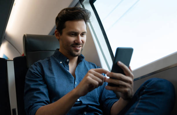 istock Man traveling by train and checking his social media 1072601604