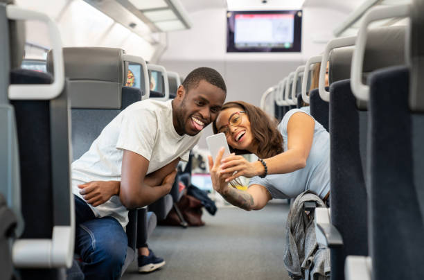 istock Couple traveling by train and taking a selfie 1072601706