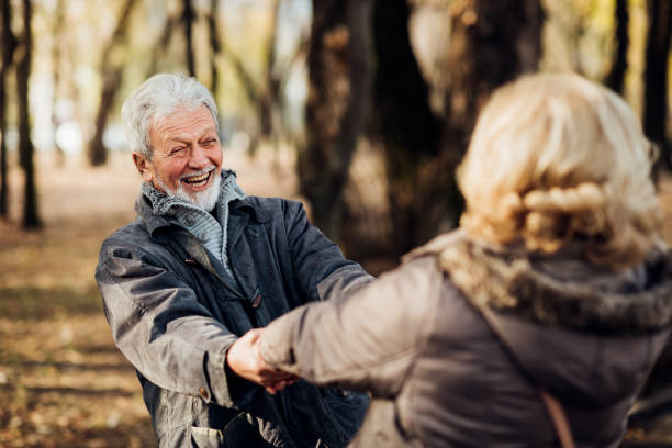 istock Senior couple romantically holding hands in the park 1072604360