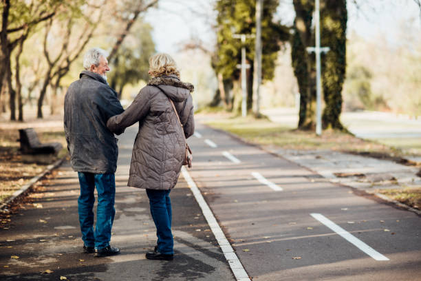 istock Happy senior couple taking a walk in the park 1072604402