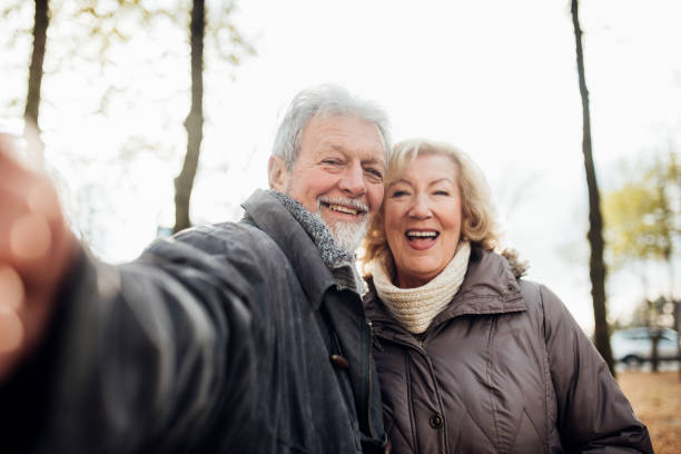 istock Senior couple in the park taking a selfie 1072604512
