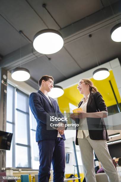 Colleague Chit Chat On A Break Stock Photo - Download Image Now - 20-24 Years, Adult, Adults Only