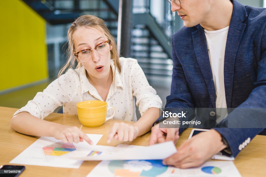 See? This digits aren't matching Coworkers arguing about work, researching, brainstorming new ideas. 20-24 Years Stock Photo