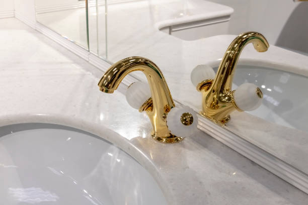 istock Beautiful golden mixer on a marble sink 1072608572