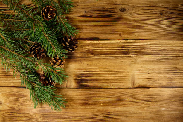 istock Christmas composition with fir tree branches and cones on wooden background. Top view, copy space 1072608732
