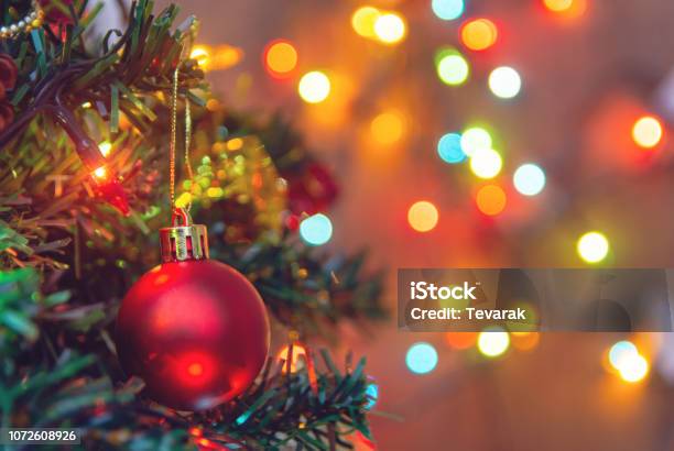 Christmas Decoration Hanging Red Balls On Pine Branches Christmas Tree Garland And Ornaments Over Abstract Bokeh Background With Copy Space Stock Photo - Download Image Now