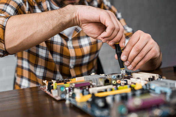 istock cropped shot of computer engineer repairing motherboard with screwdriver 1072609480