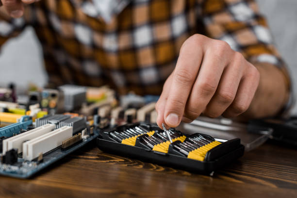 istock computer engineer taking screwdriver caps to repair motherboard 1072609486