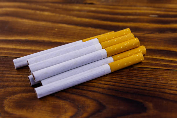 istock Tobacco cigarettes on wooden table 1072611500