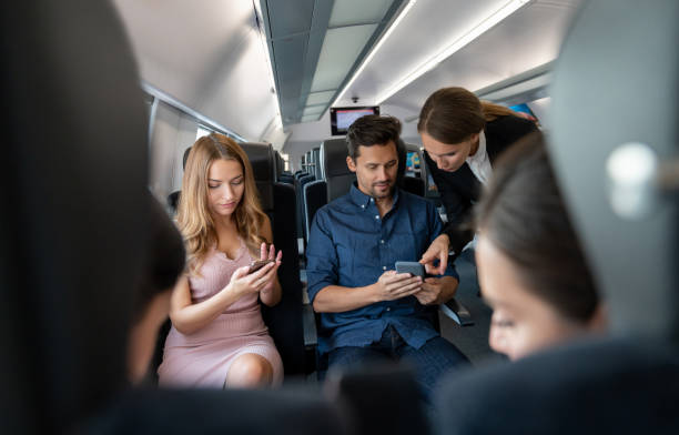 istock Train attendant talking to some passengers and checking their tickets 1072612532